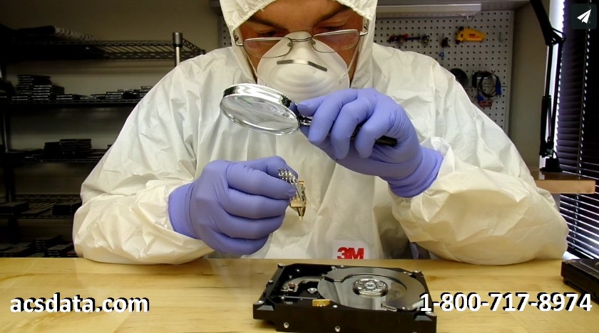 Inspecting read-write heads on a Seagate hard drive that was dropped.